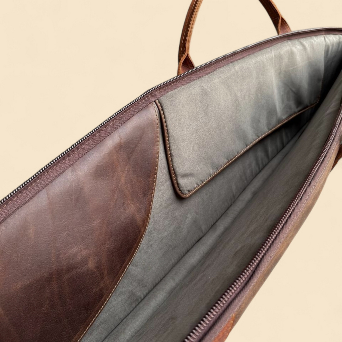 Ngozi Collection chocolate leather rifle bag showing full-length zip and leather trim