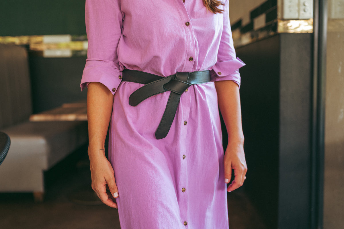 Woman wearing Ngozi Collection green leather wrap belt with pink dress