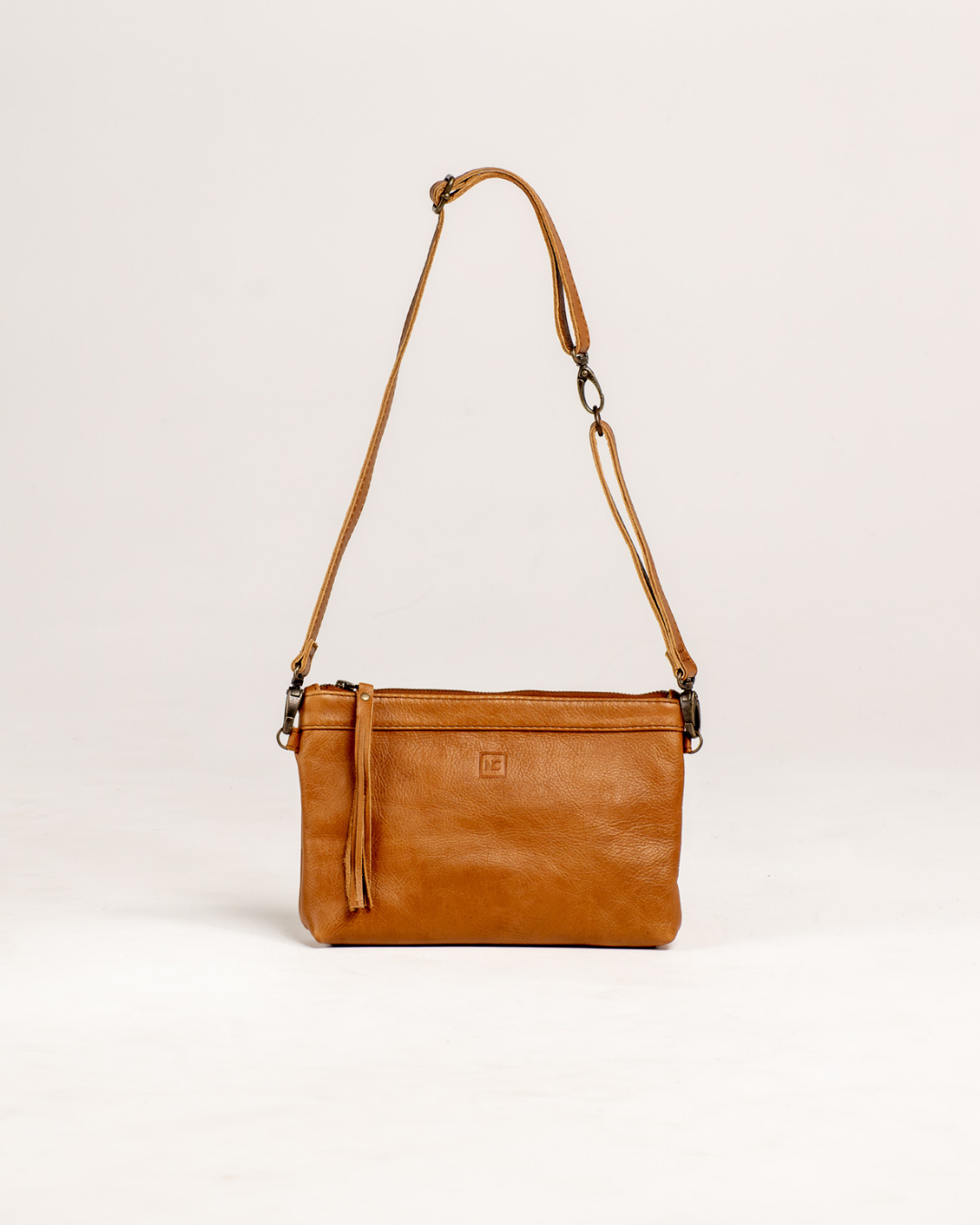 Ngozi Collection tan leather sling bag