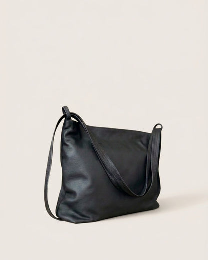 Ngozi Collection black leather slouch bag with adjustable strap, side view