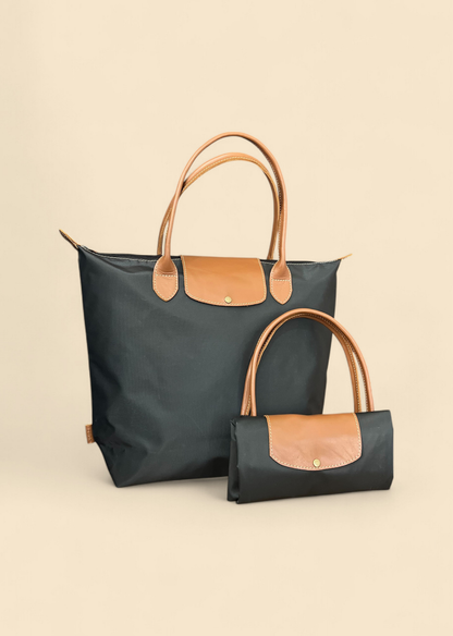 Ngozi Collection black nylon foldable shopper tote shown folded and open