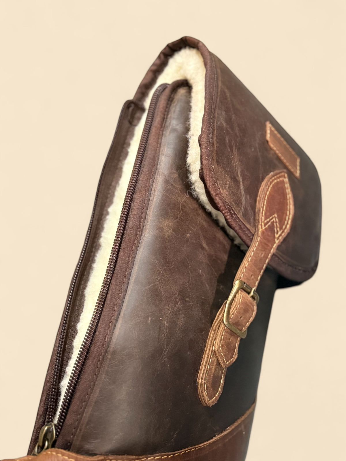 Ngozi Collection chocolate leather shotgun sleeve open, showing wool lining
