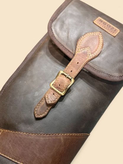 Ngozi Collection chocolate leather shotgun sleeve showing buckle flap detail
