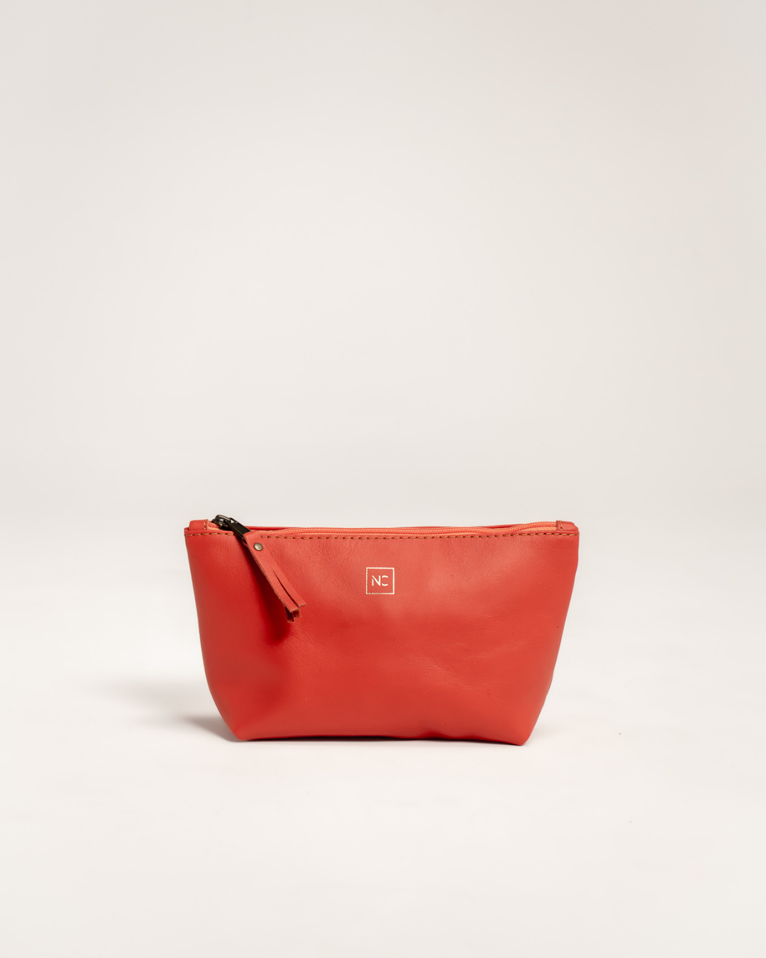 Ngozi Collection coral leather makeup bag with zipper pull