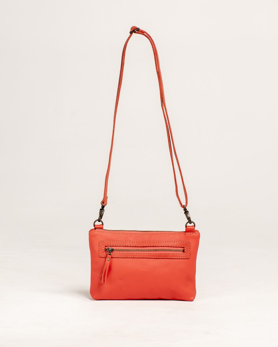 Ngozi Collection coral leather sling bag showing back zip pocket