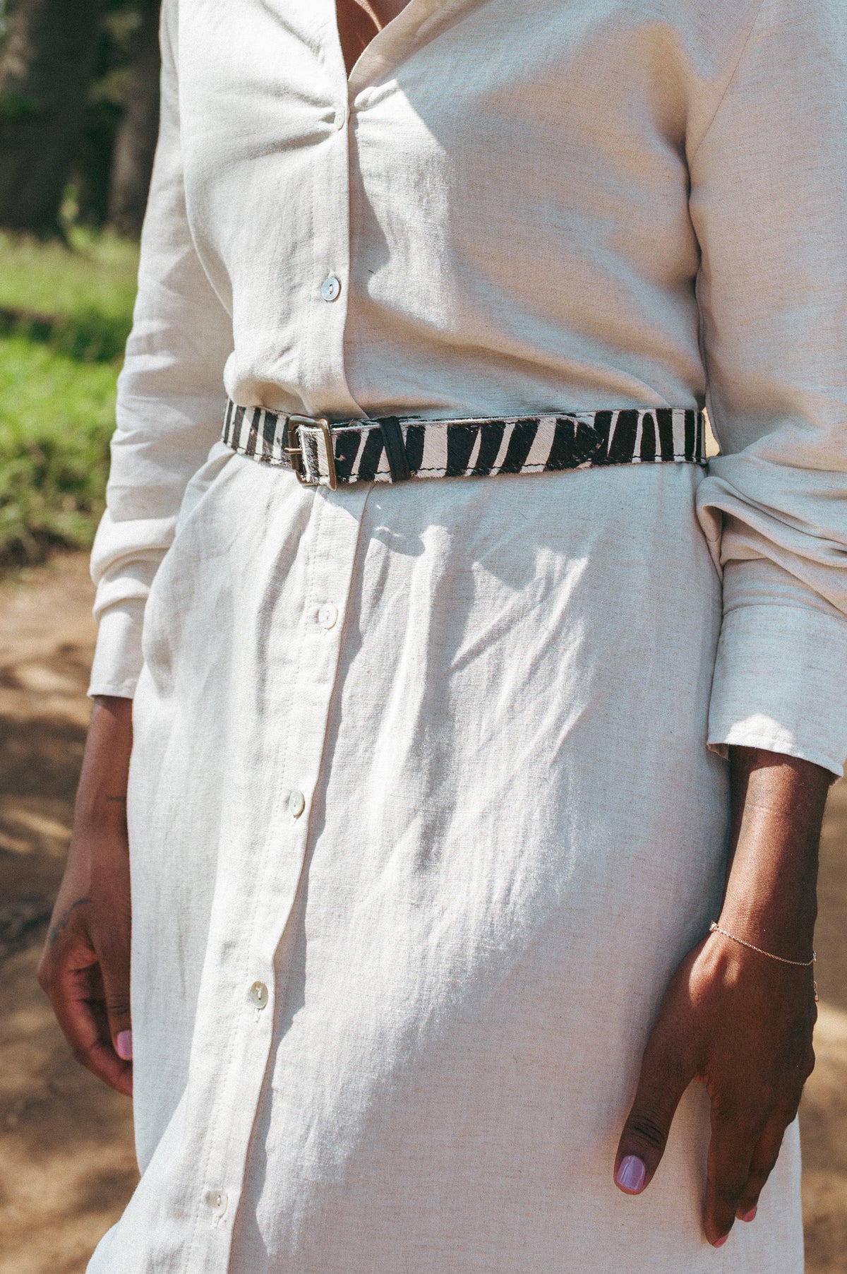 Ngozi Collection zebra print hide ladies belt worn over a linen skirt