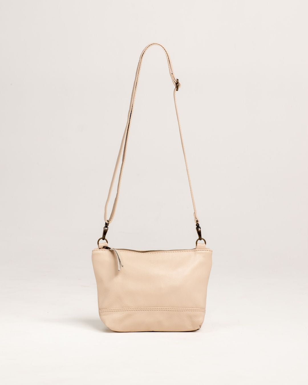 Ngozi Collection latte leather sling bag with adjustable strap