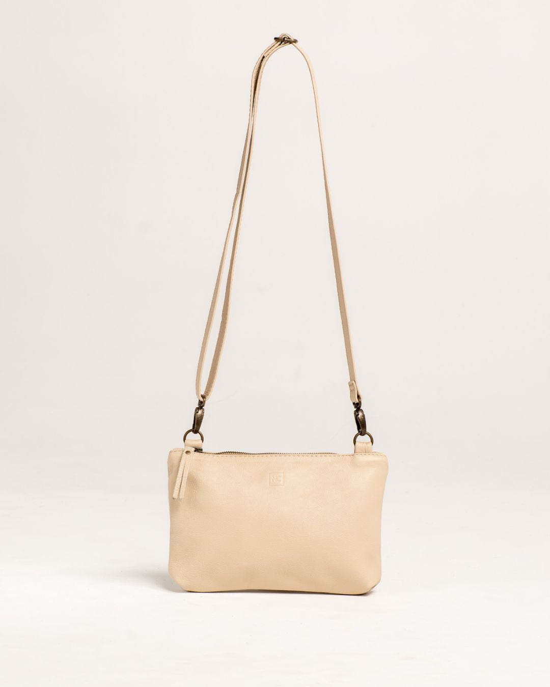 Ngozi Collection latte leather sling bag with adjustable strap
