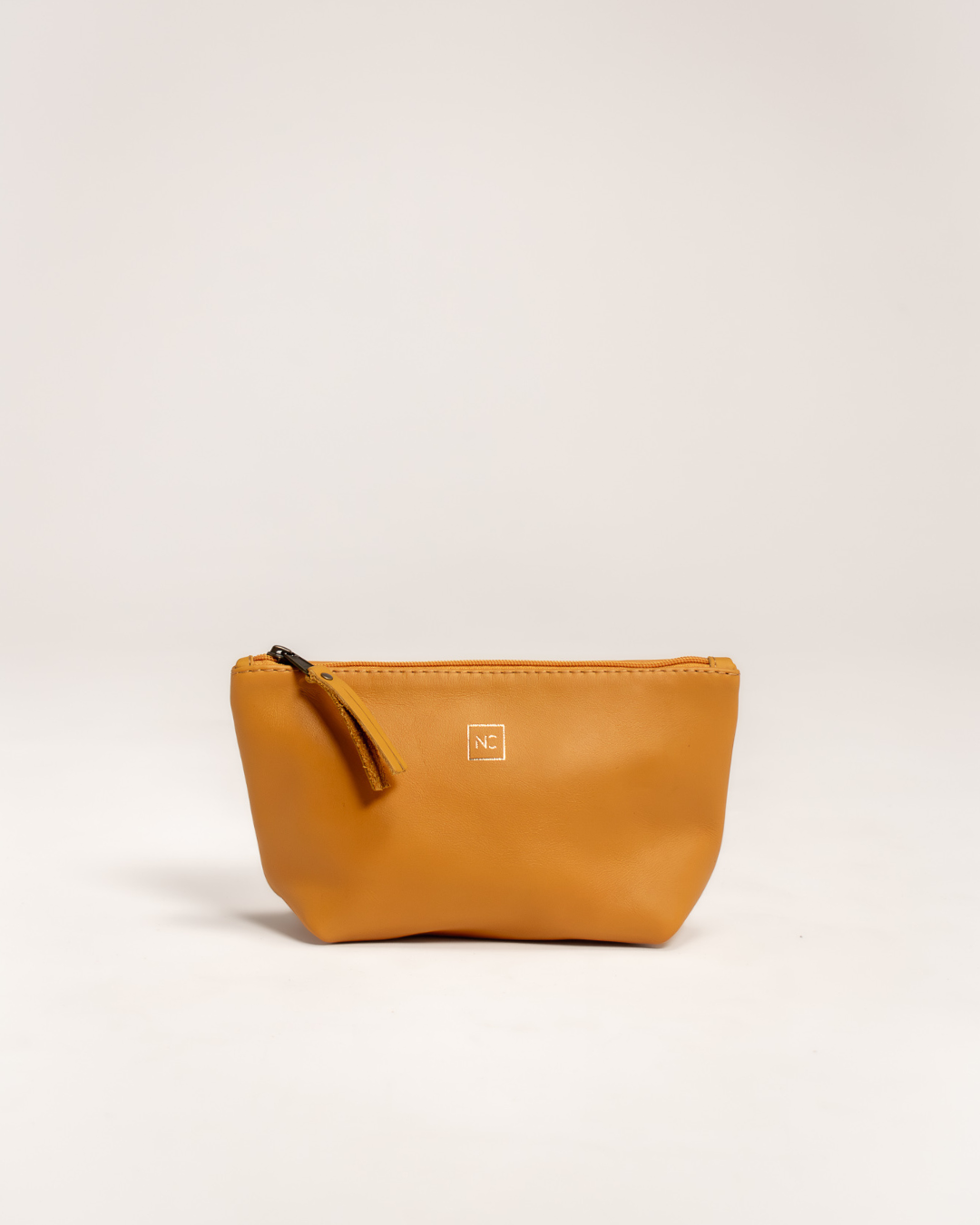 Ngozi Collection mustard leather makeup bag with zipper pull