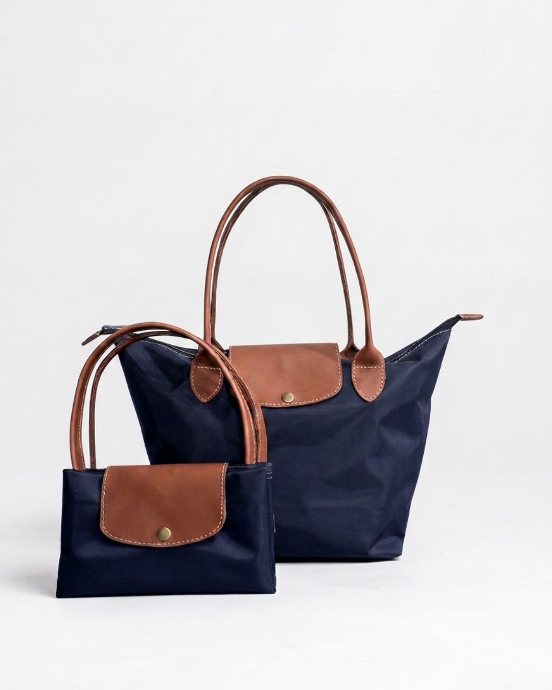 Ngozi Collection navy nylon foldable shopper tote shown folded and open