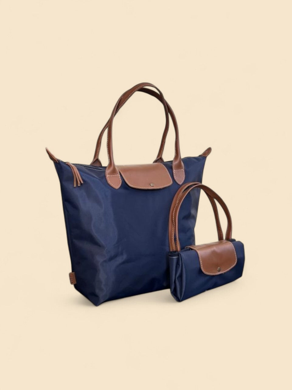 Ngozi Collection navy nylon foldable shopper tote shown folded and open