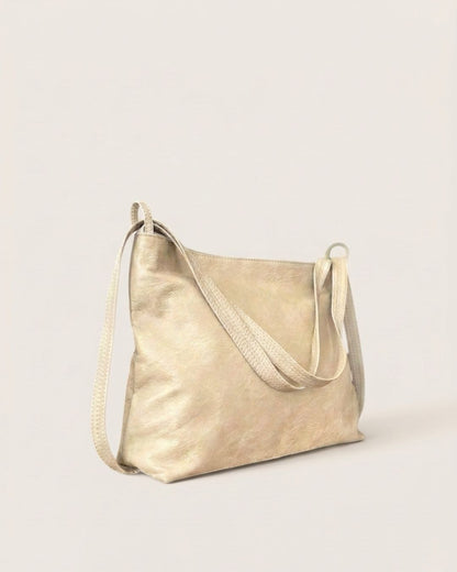 Ngozi Collection oat leather slouch bag with adjustable strap, side view
