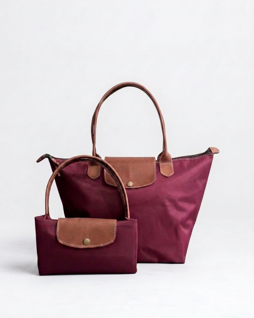 Ngozi Collection plum nylon foldable shopper tote shown folded and open