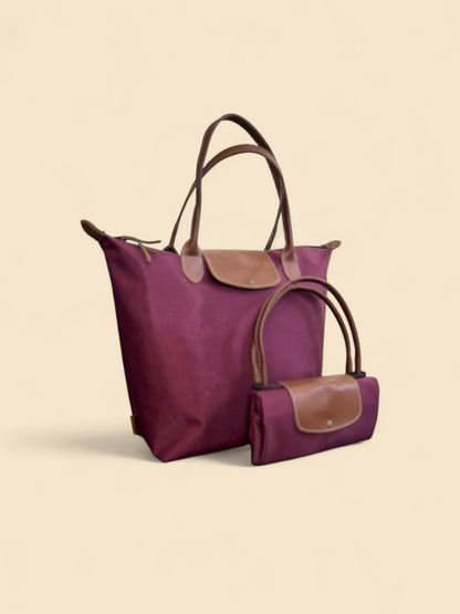 Ngozi Collection plum nylon foldable shopper tote shown folded and open