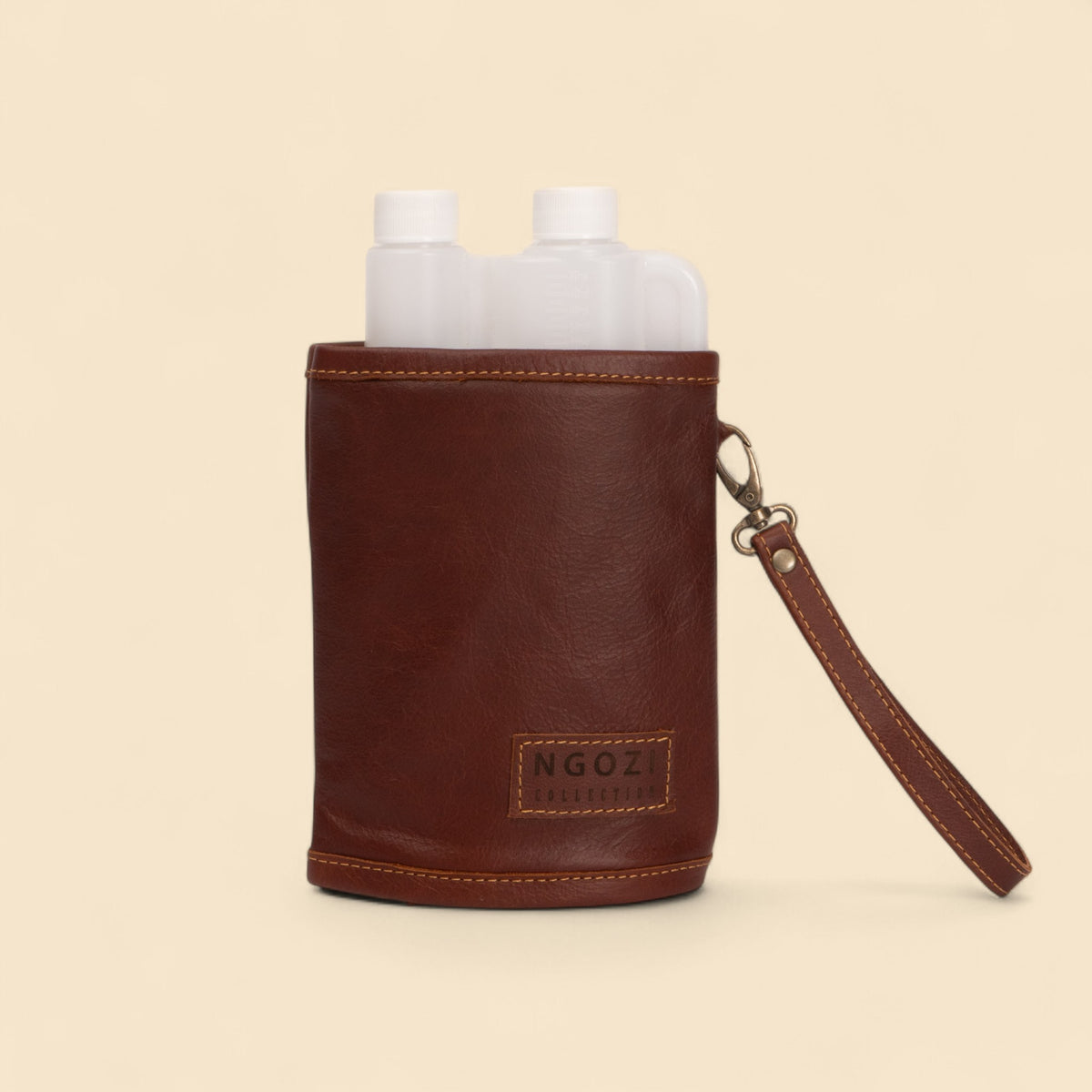 Ngozi Collection rust leather tot bottle cover with wrist strap