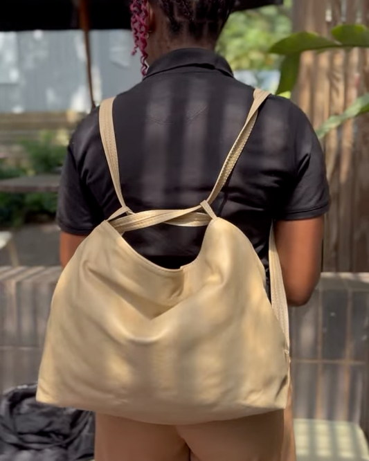 Ngozi Collection oat leather slouch bag worn as a backpack