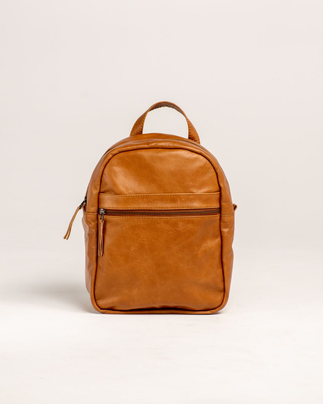Ngozi Collection tan leather backpack with front zip pocket