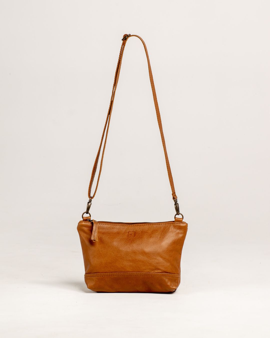 Ngozi Collection tan leather sling bag with adjustable strap