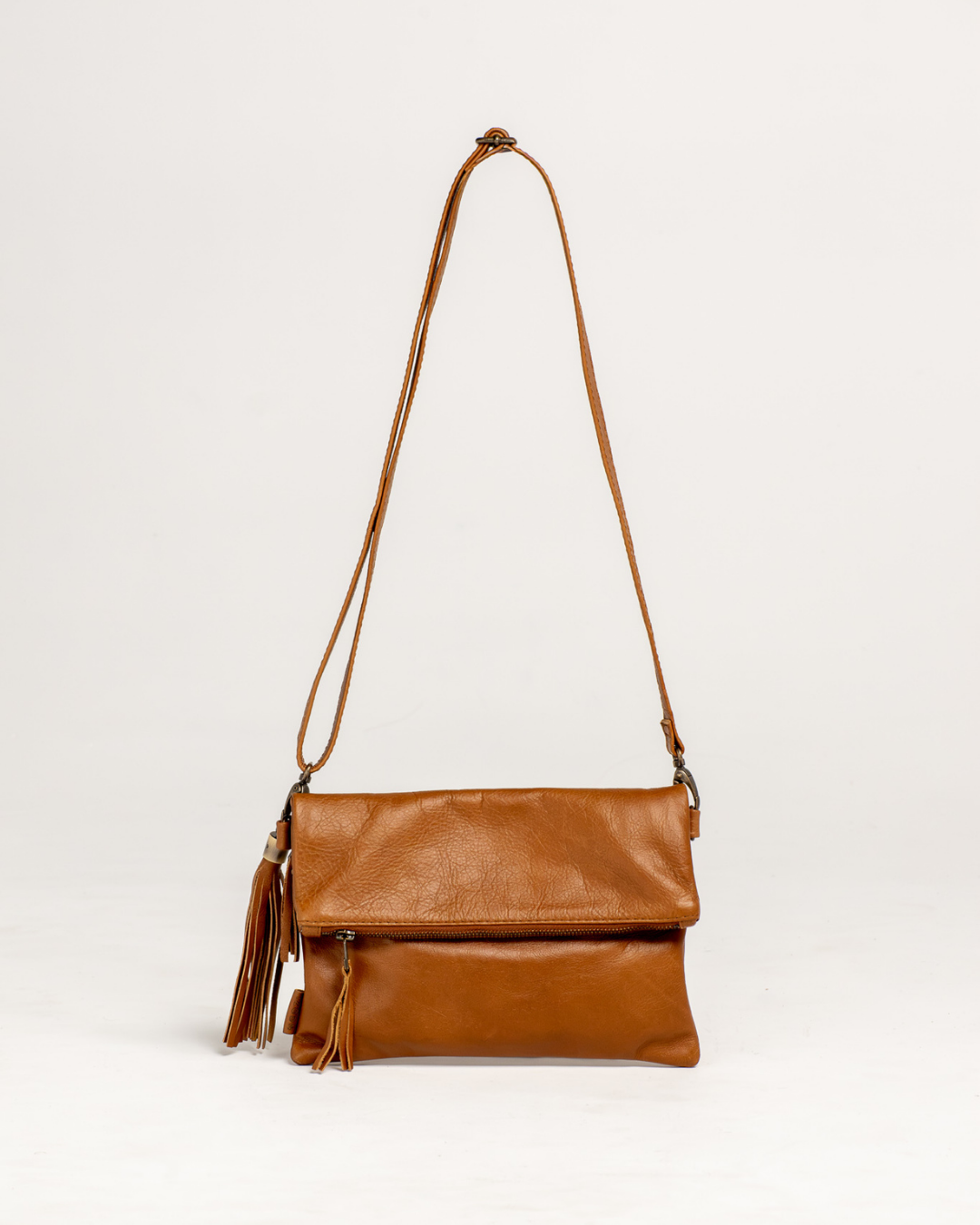 Ngozi Collection tan leather clutch and sling bag