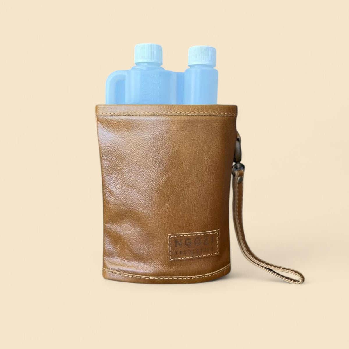 Ngozi Collection tan leather tot bottle cover with wrist strap