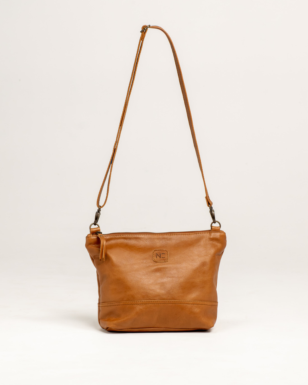 Ngozi Collection tan leather sling bag