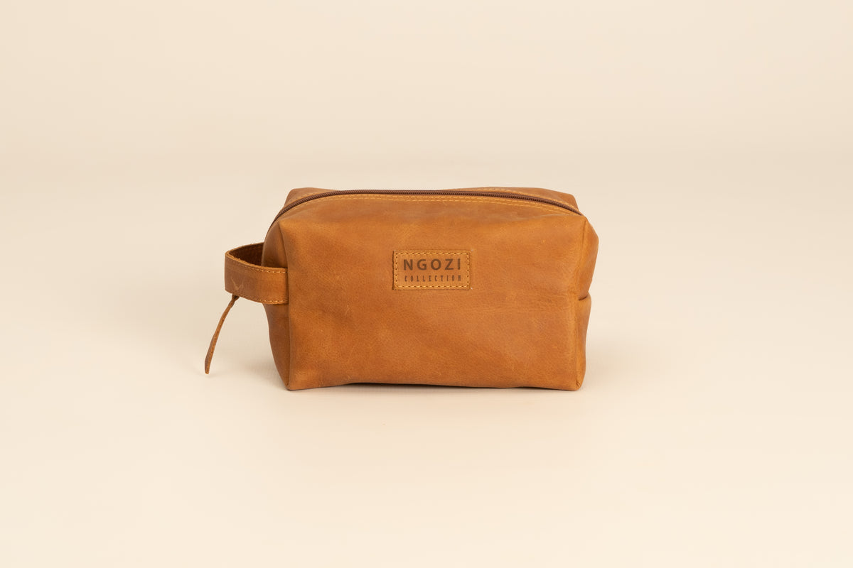 Ngozi Collection tan leather toiletry bag with zip closure and side handle